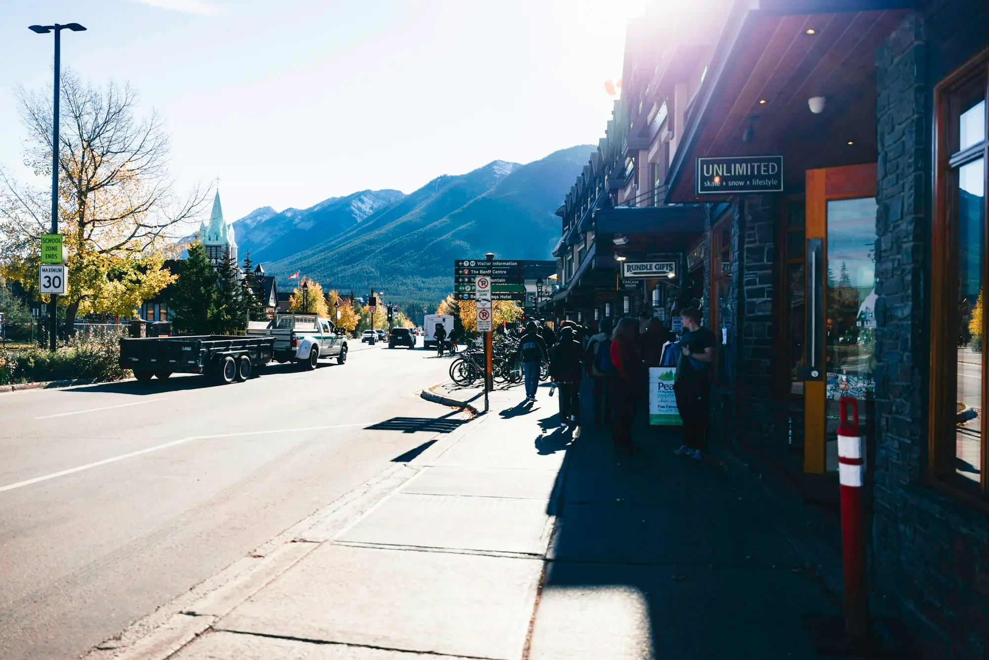 Sunny street with shops and mountains behind