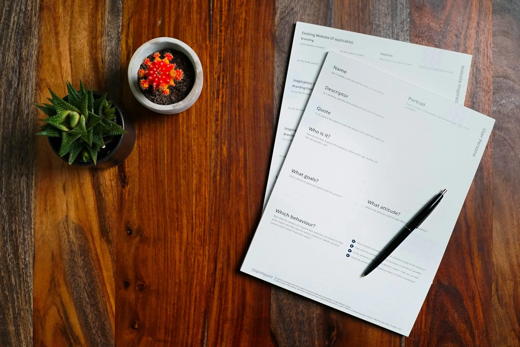 Paperwork and a pen on a wooden table